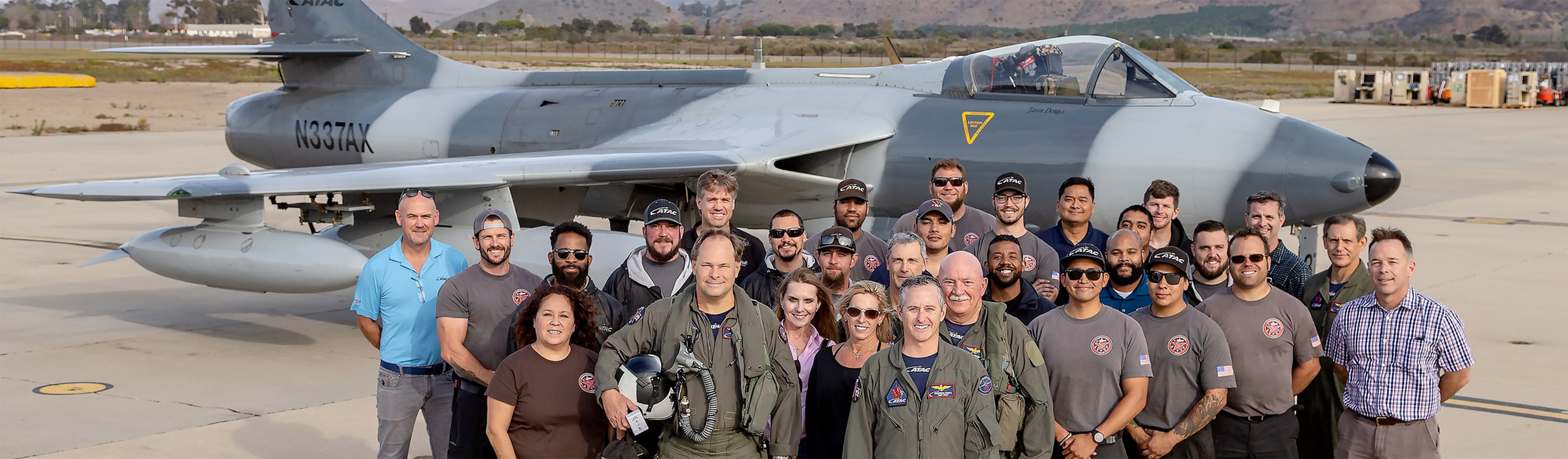 ATAC Team members in front of a ATAC fighter plane.